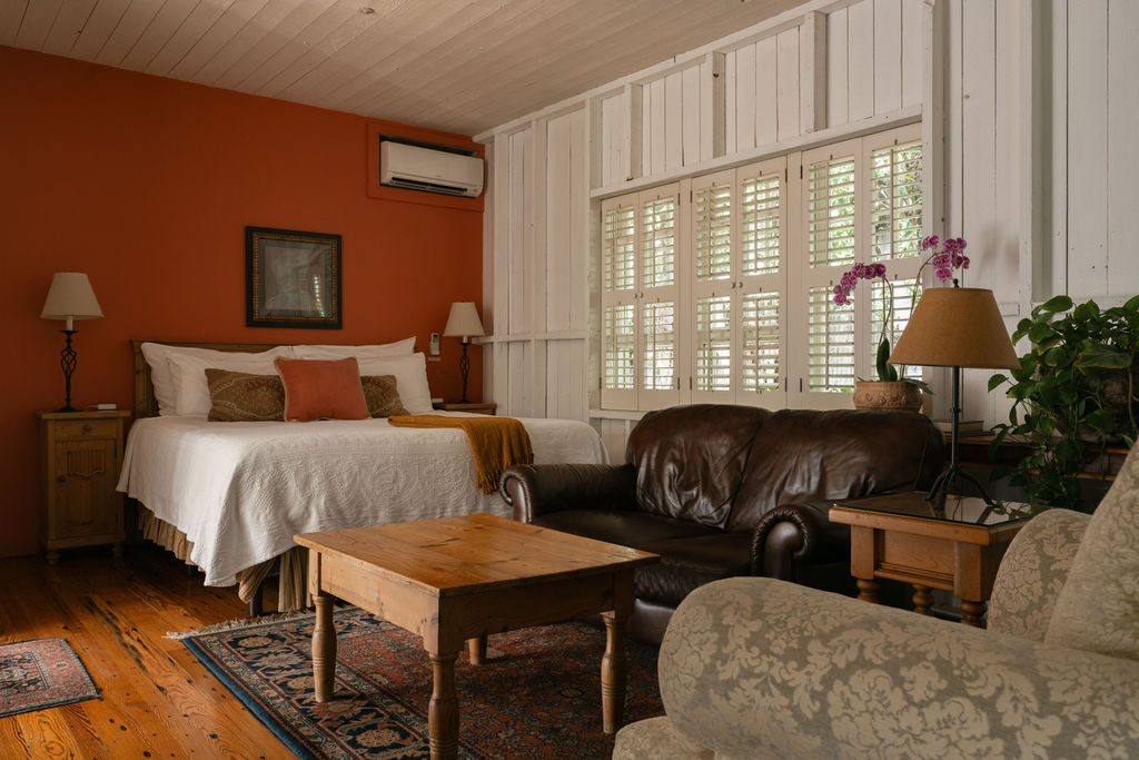 The king bed and antique furnishings in the ADA Carriage Room
